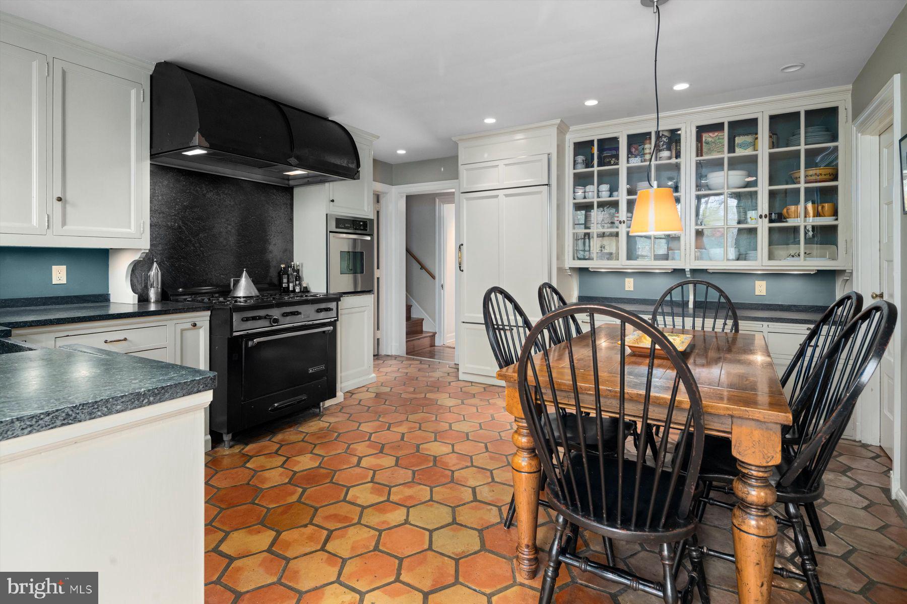 95 West Hampton Road Philadelphia, PA 19118 - Photo 15 of 37 a kitchen with stainless steel appliances granite countertop a stove a sink a refrigerator dining table and chairs