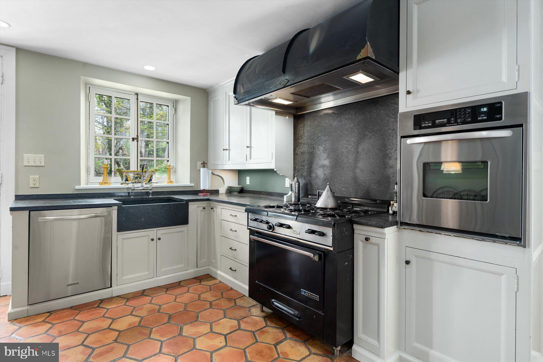 95 West Hampton Road Philadelphia, PA 19118 - Photo 16 of 37 a kitchen with stainless steel appliances a stove a sink and a microwave