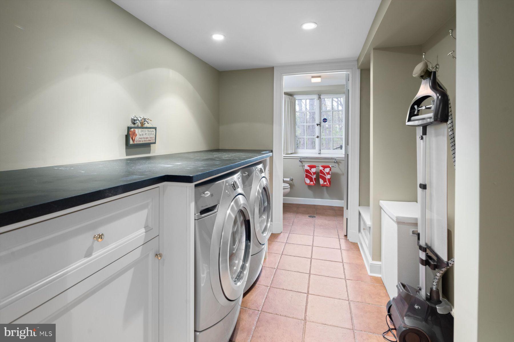 95 West Hampton Road Philadelphia, PA 19118 - Photo 19 of 37 a utility room with cabinets washer and dryer