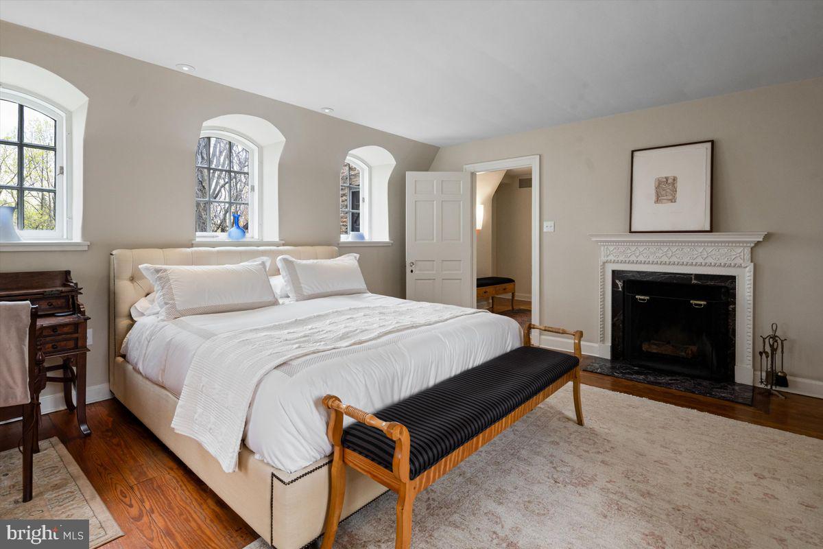 95 West Hampton Road Philadelphia, PA 19118 - Photo 24 of 37 a spacious bedroom with a bed and a fireplace