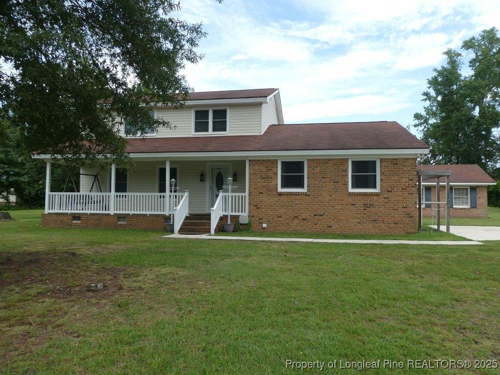 263 Forest Road Lumberton, NC 28358 - Photo 1 of 44 a front view of a house with a garden
