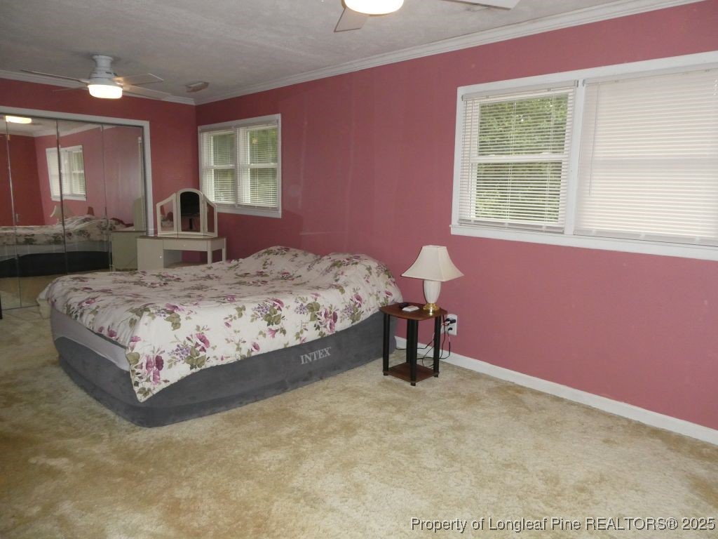 263 Forest Road Lumberton, NC 28358 - Photo 11 of 44 a bedroom with a bed and a table
