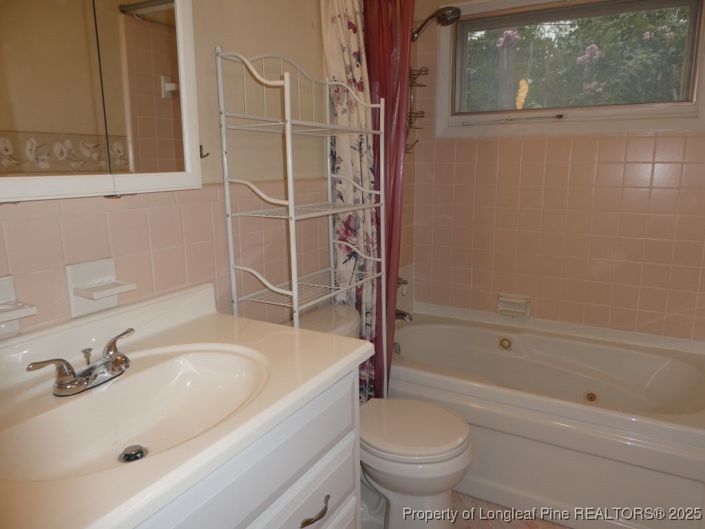263 Forest Road Lumberton, NC 28358 - Photo 17 of 44 a bathroom with a sink toilet and shower