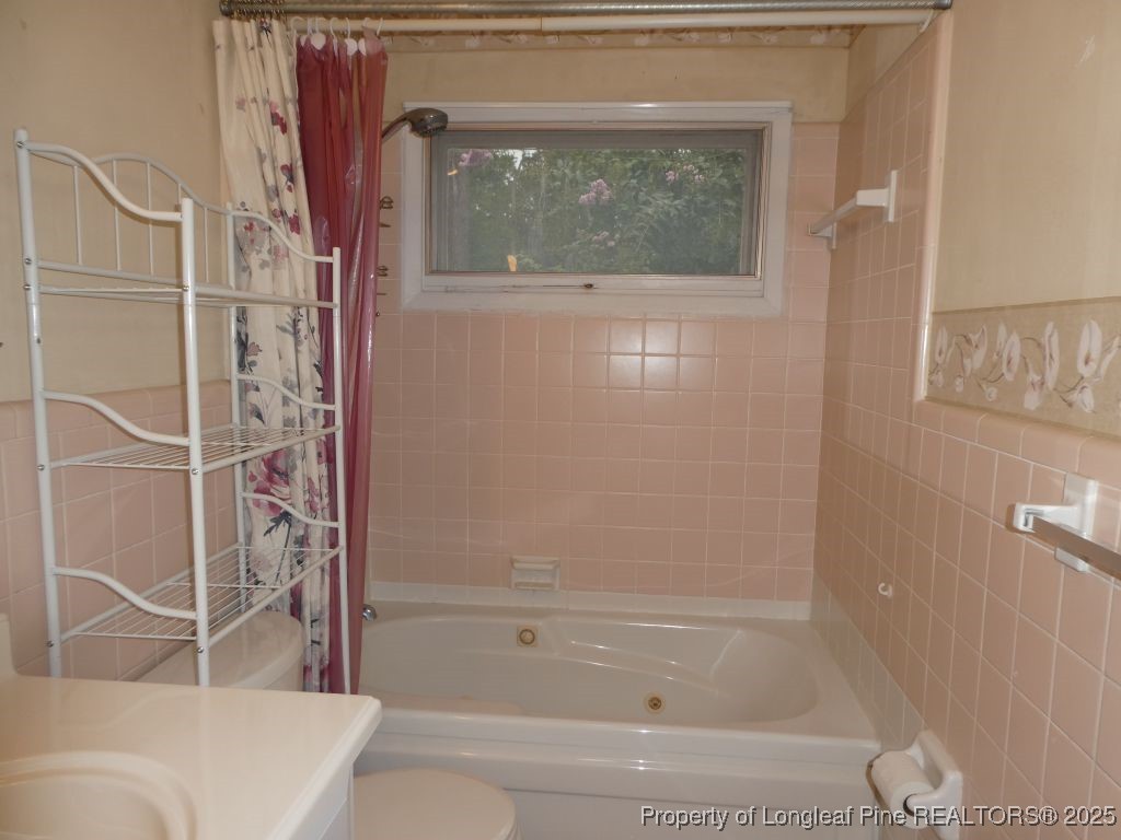 263 Forest Road Lumberton, NC 28358 - Photo 19 of 44 a bathroom with a bathtub and a shower
