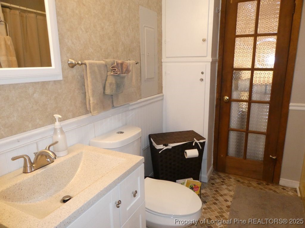 263 Forest Road Lumberton, NC 28358 - Photo 24 of 44 a bathroom with a sink a toilet and a mirror