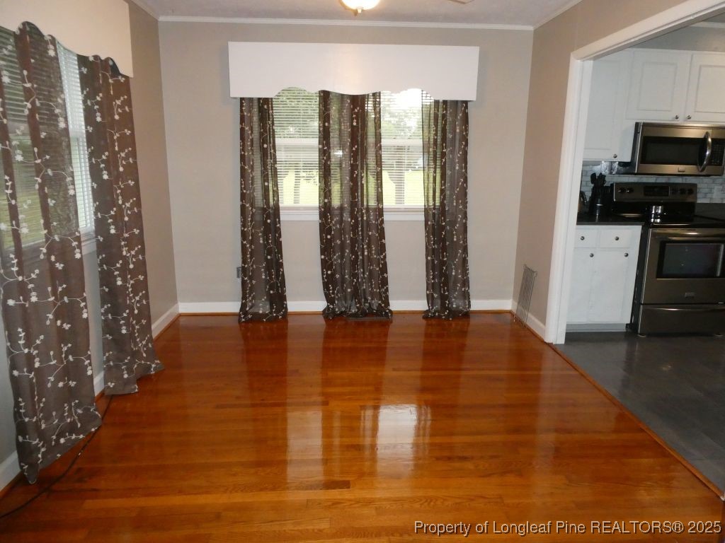 263 Forest Road Lumberton, NC 28358 - Photo 25 of 44 a view of an empty room with window and hardwood floor