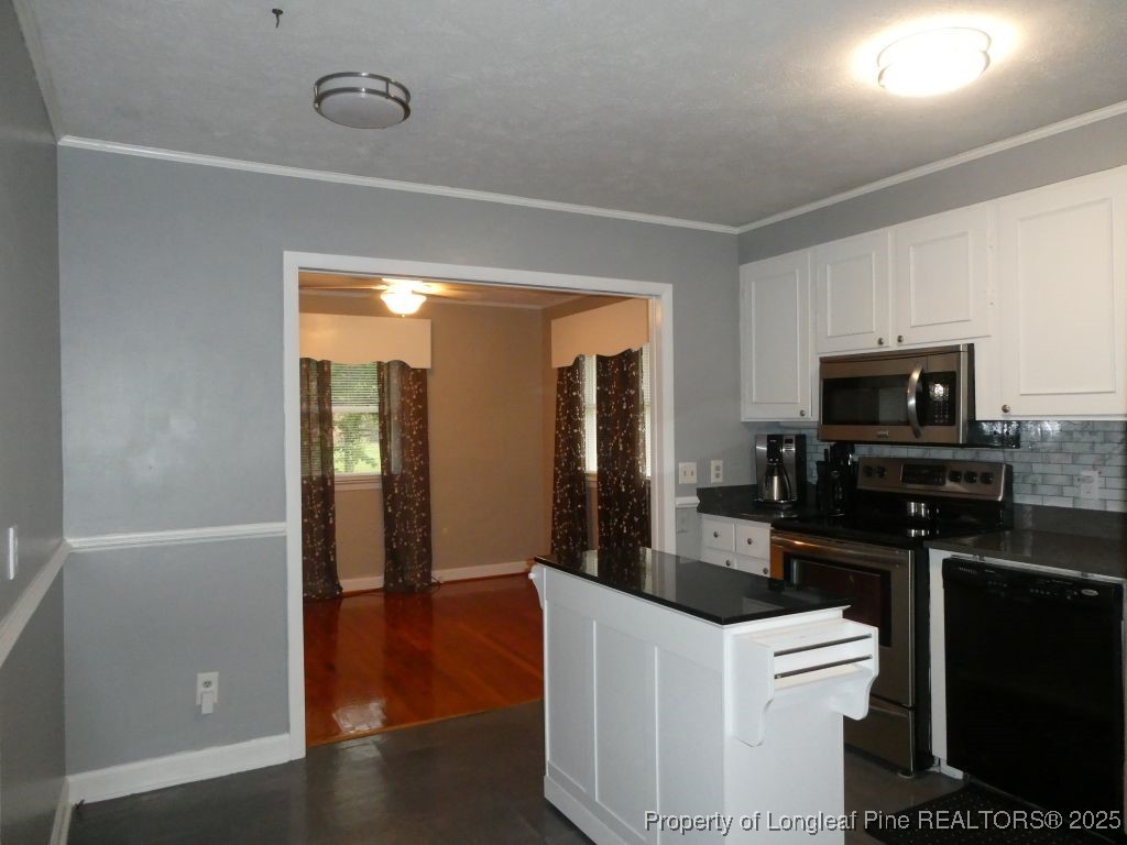 263 Forest Road Lumberton, NC 28358 - Photo 27 of 44 a kitchen with a refrigerator and a stove top oven