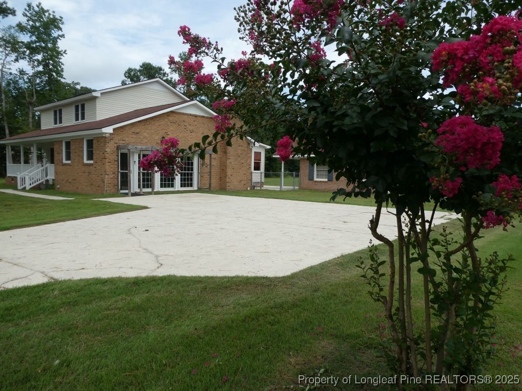 263 Forest Road Lumberton, NC 28358 - Photo 28 of 44 a front view of a house with a yard and a garage