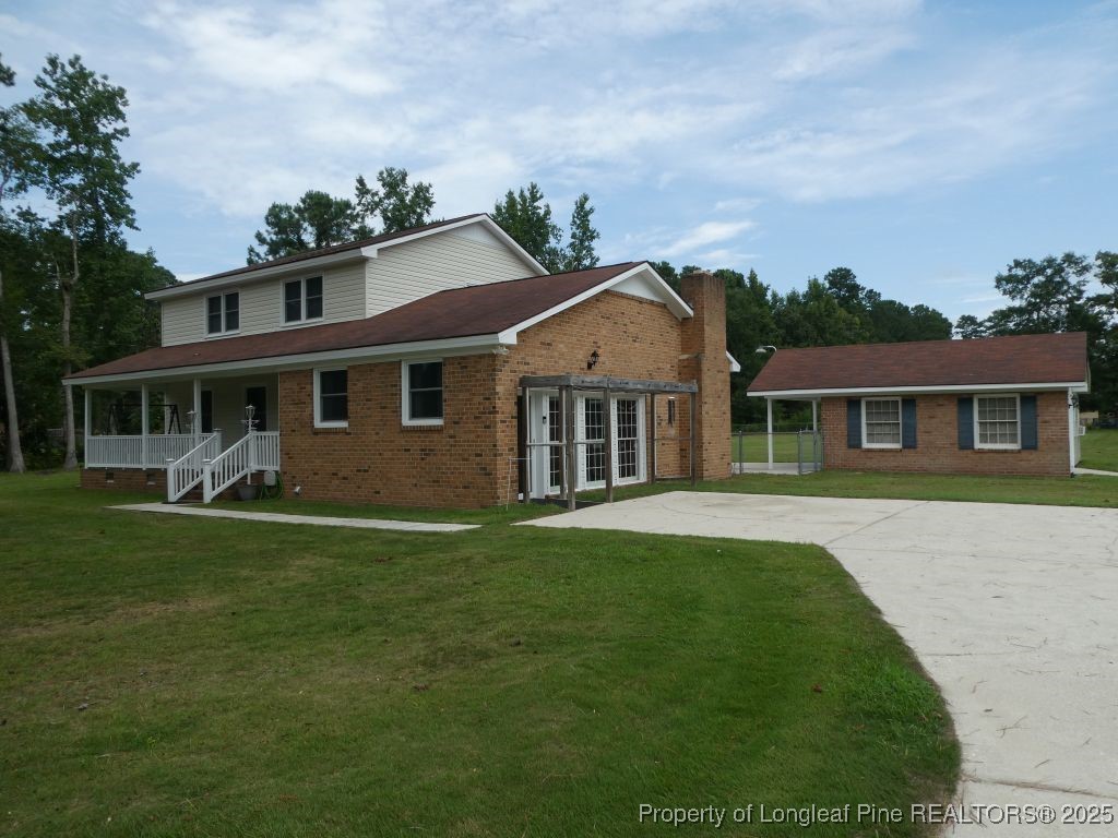 263 Forest Road Lumberton, NC 28358 - Photo 29 of 44 a front view of a house with a garden