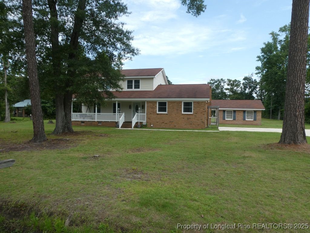 263 Forest Road Lumberton, NC 28358 - Photo 30 of 44 a front view of a house with a garden