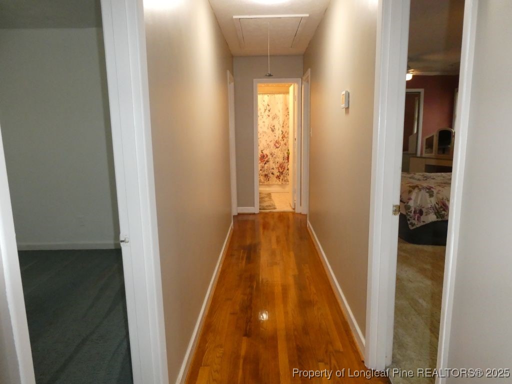 263 Forest Road Lumberton, NC 28358 - Photo 32 of 44 a view of a hallway with wooden floor and a bathroom