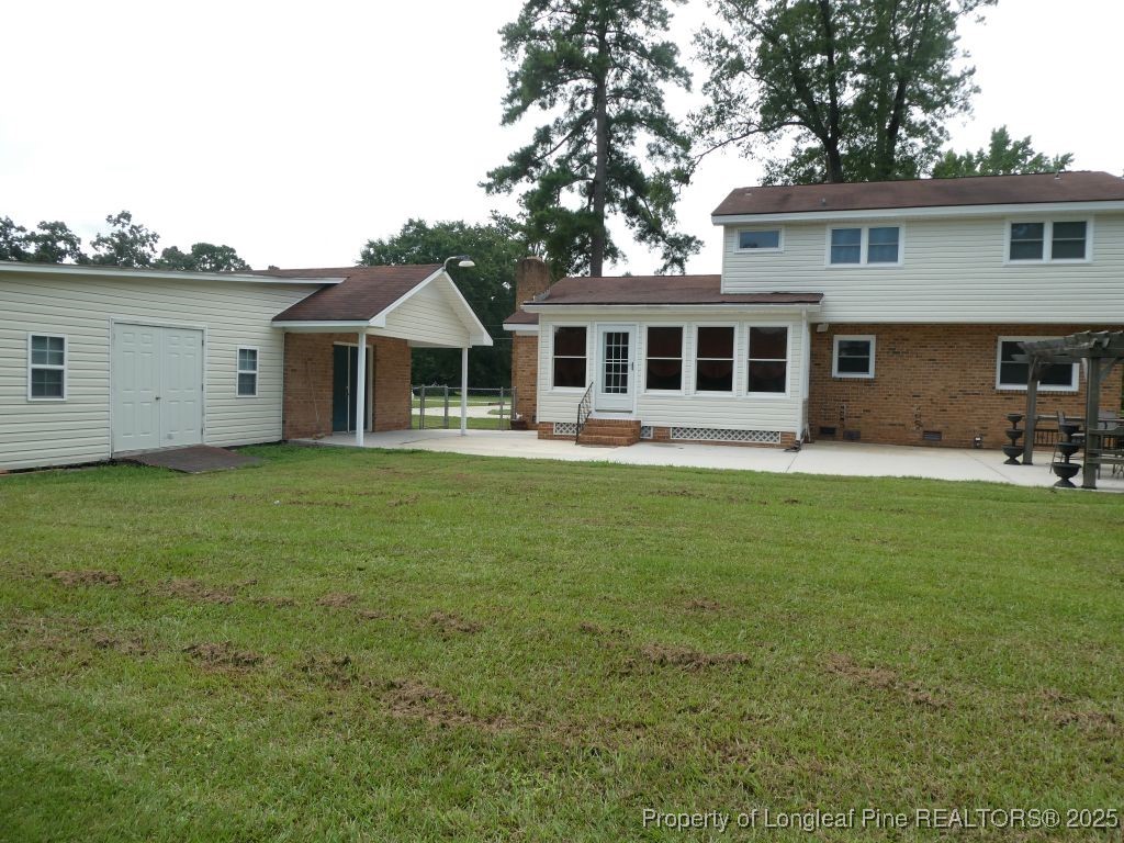 263 Forest Road Lumberton, NC 28358 - Photo 34 of 44 a front view of a house with a garden and trees