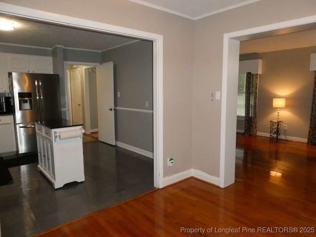 263 Forest Road Lumberton, NC 28358 - Photo 6 of 44 a view of a hallway with wooden floor and a living room