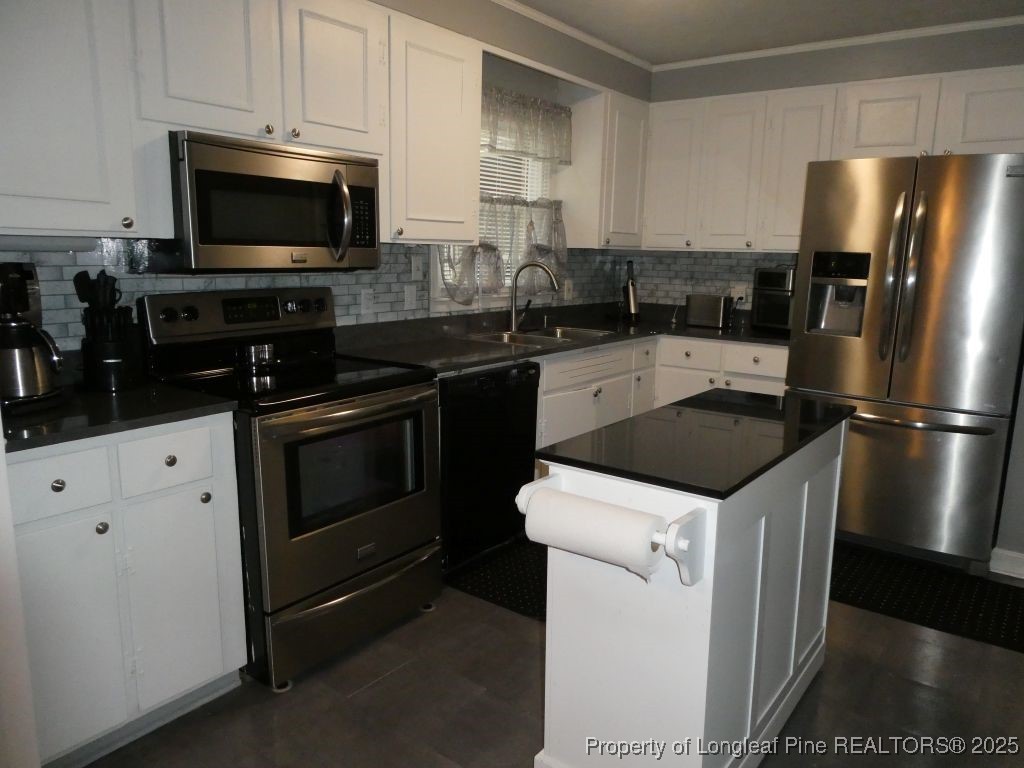 263 Forest Road Lumberton, NC 28358 - Photo 7 of 44 a kitchen with stainless steel appliances a stove microwave and refrigerator