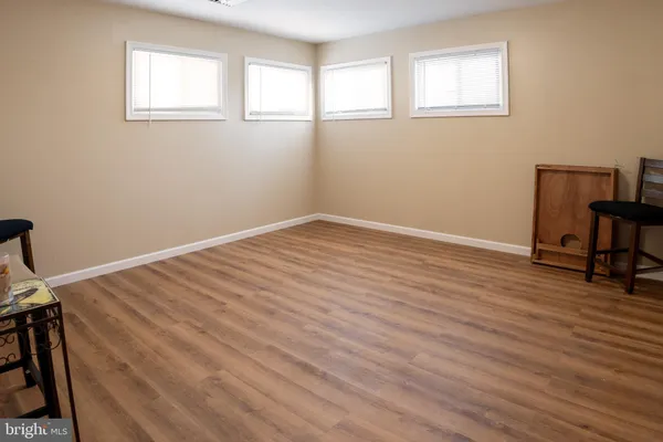 a view of a room with wooden floor and windows