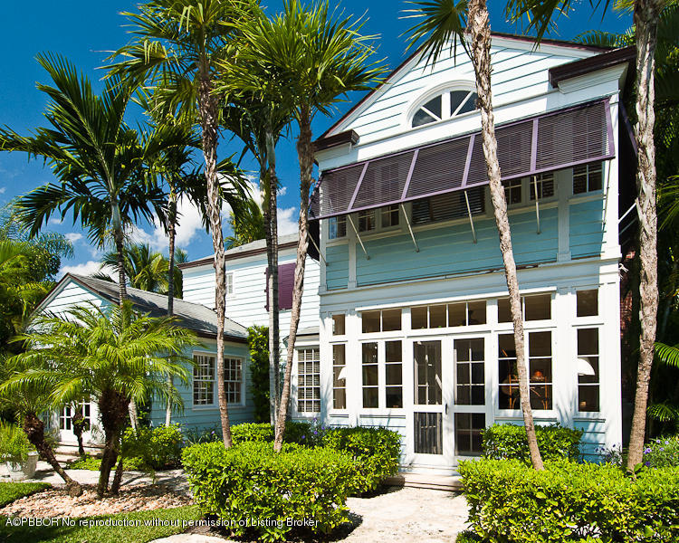 266 Monterey Road Palm Beach, FL 33480 - Photo 14 of 16 a view of a white house with a large window and a yard with potted plants