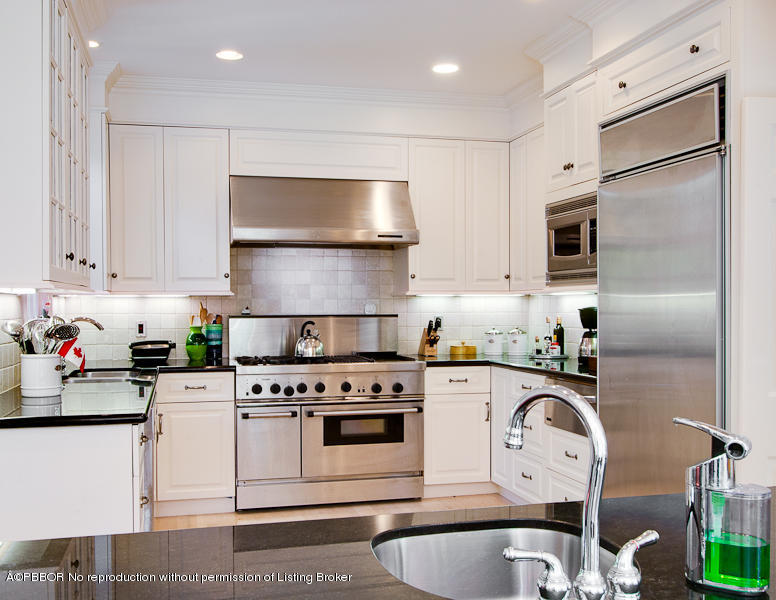 266 Monterey Road Palm Beach, FL 33480 - Photo 6 of 16 a kitchen with granite countertop a sink stainless steel appliances and white cabinets