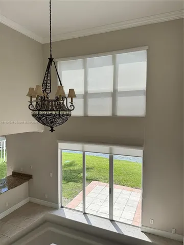 a view of a floor to ceiling window and a chandelier