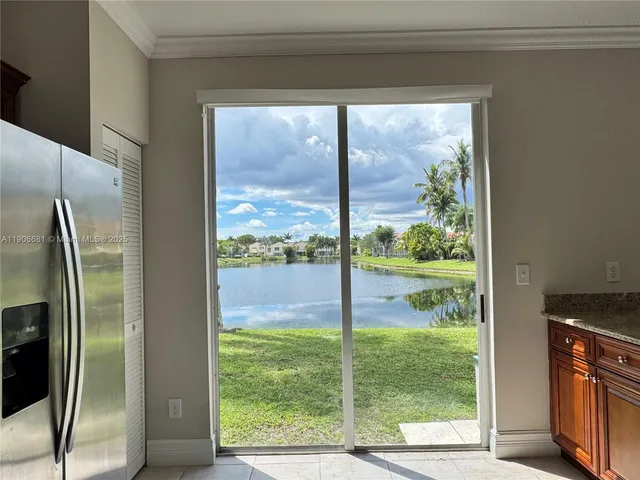 a view of a glass door and a yard