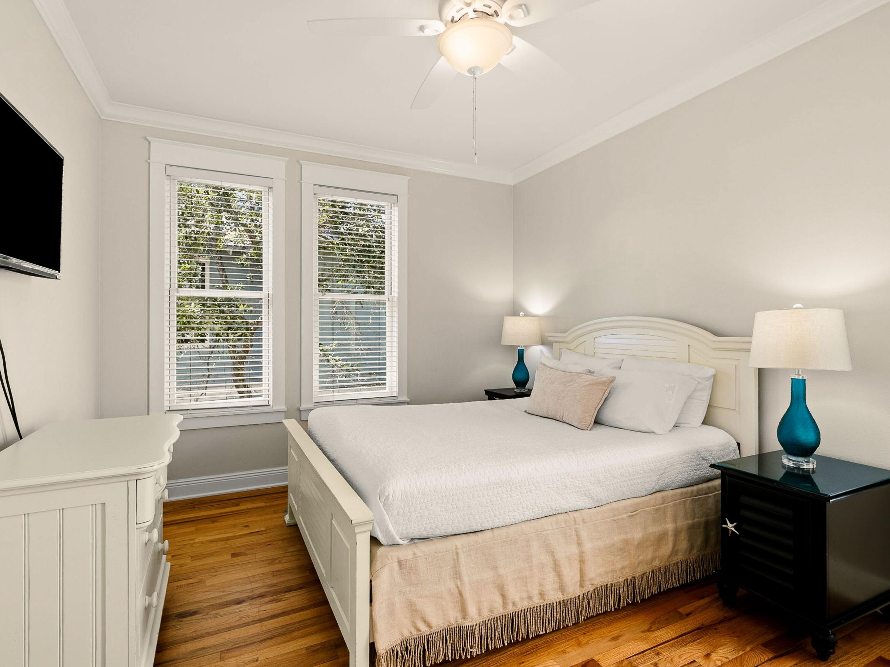 107 Chelsea Loop Road Santa Rosa Beach, FL 32459 - Photo 18 of 28 a spacious bedroom with a bed and a flat tv screen on dresser