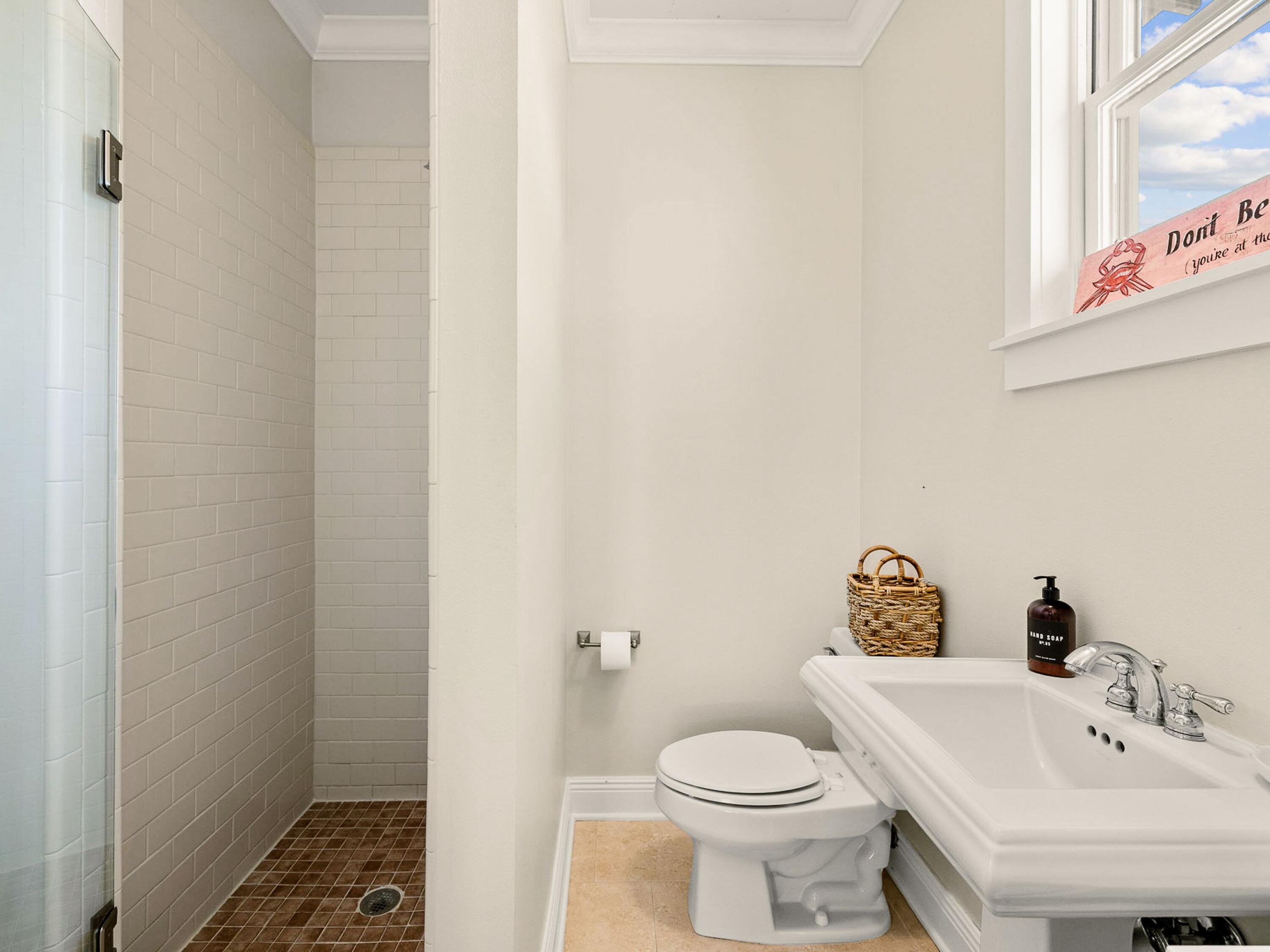 107 Chelsea Loop Road Santa Rosa Beach, FL 32459 - Photo 23 of 28 a white toilet sitting next to a bathroom sink