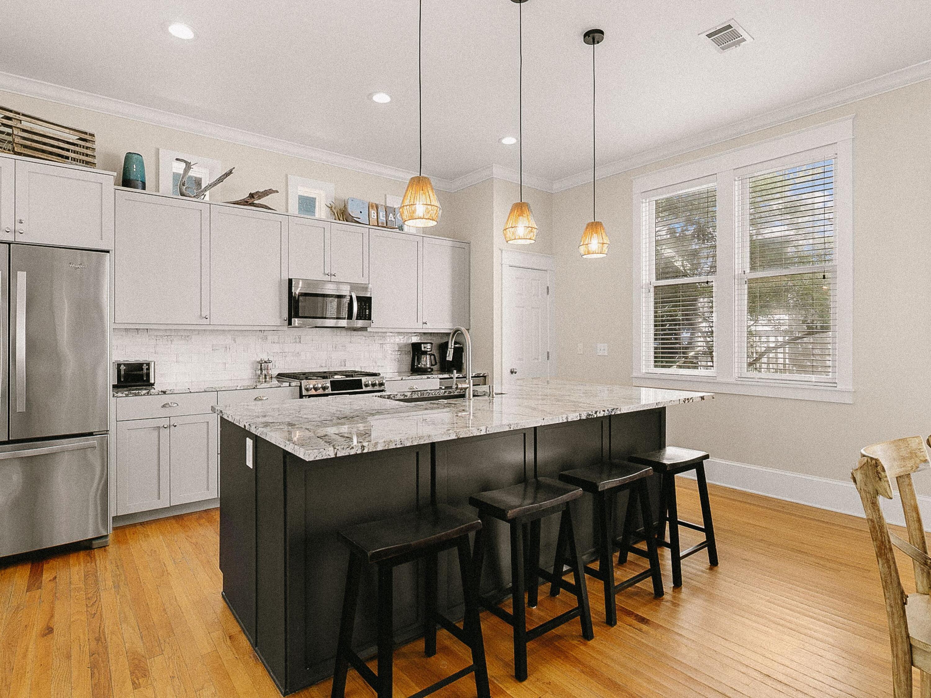 107 Chelsea Loop Road Santa Rosa Beach, FL 32459 - Photo 5 of 28 a kitchen with a dining table chairs sink and cabinets