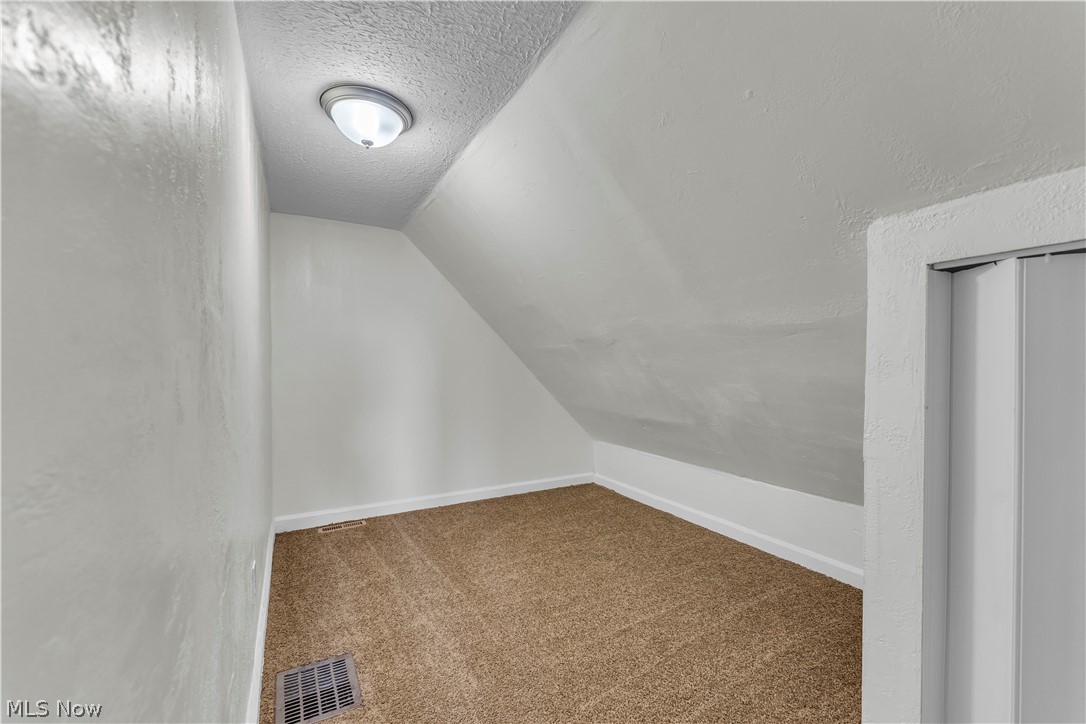12905 Watterson Avenue Cleveland, OH 44105 - Photo 22 of 30 Bonus room featuring carpet and a textured wall