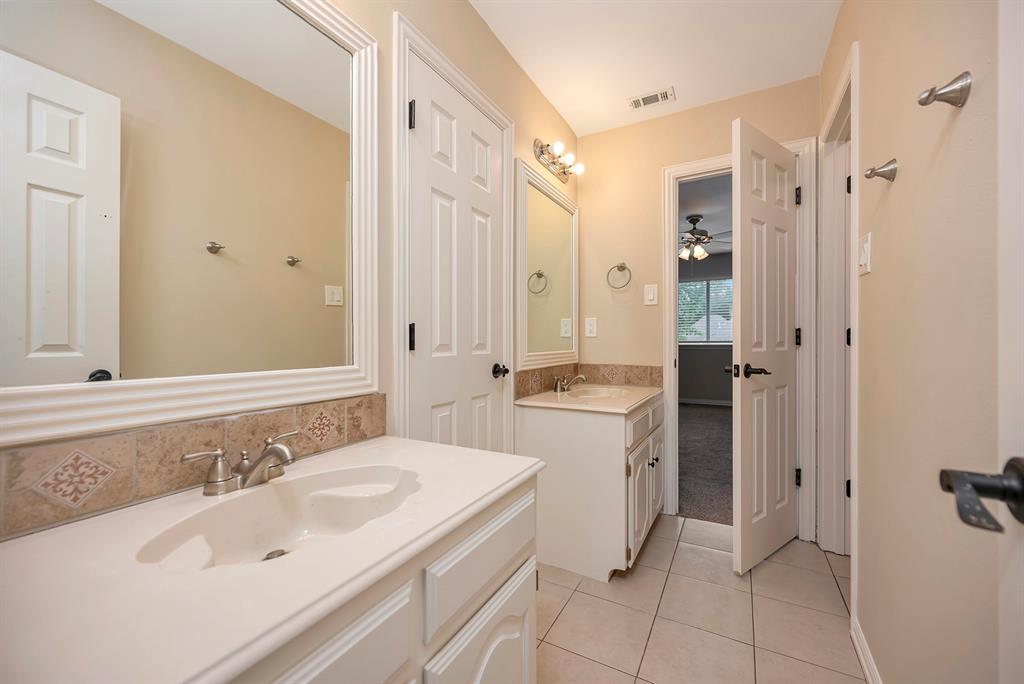 4008 Ramsgate Court Colleyville, TX 76034 - Photo 23 of 33 Upstairs Jack and Jill Dual vanity bathroom featuring integrated sinks, tile flooring, and decorative tile backsplash