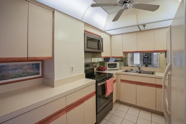 a kitchen with stainless steel appliances granite countertop a sink and cabinets