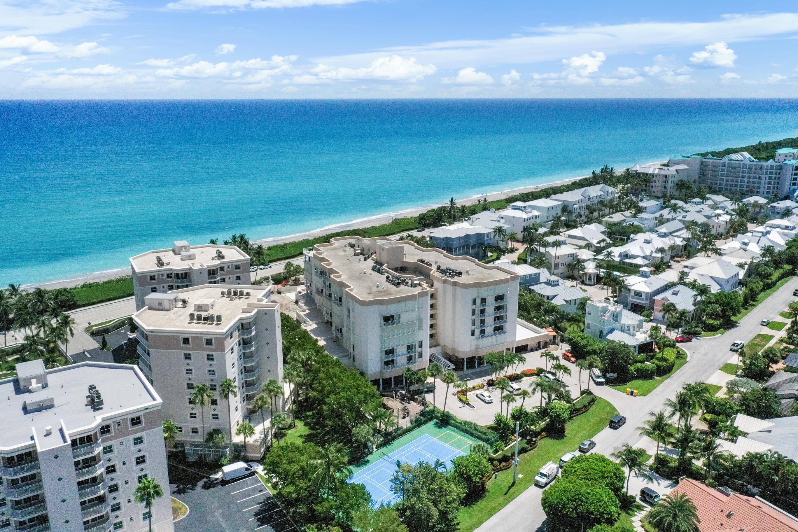 176 Helios Drive, Unit 102 Jupiter, FL 33477 - Photo 3 of 25 a view of building with outdoor space
