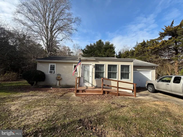 a front view of house with yard outdoor seating and barbeque oven