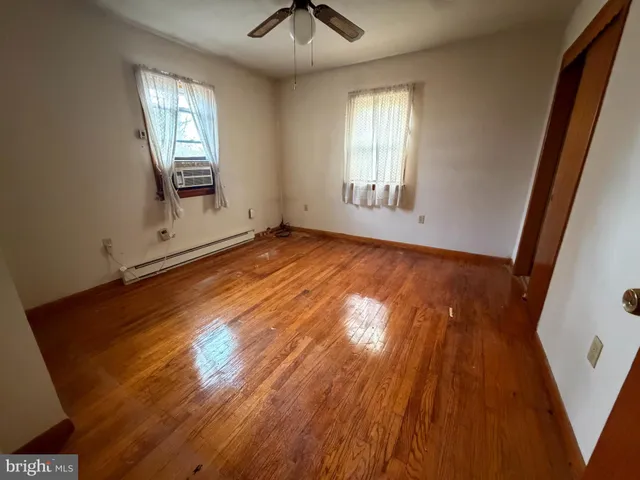 wooden floor in an empty room with a window