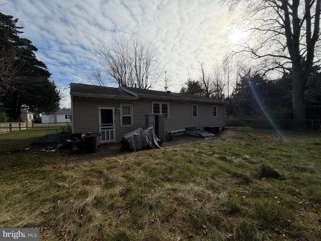 a view of a house with yard and a tree
