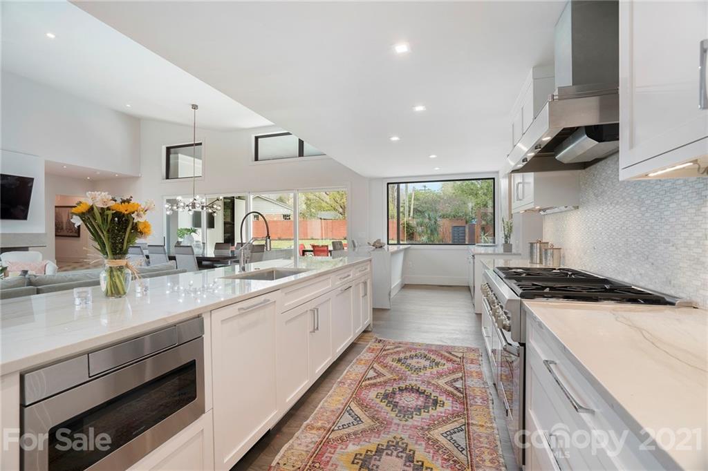 5201 Addison Drive Charlotte, NC 28211 - Photo 19 of 48 a kitchen with stainless steel appliances granite countertop a sink a stove and a wooden floors