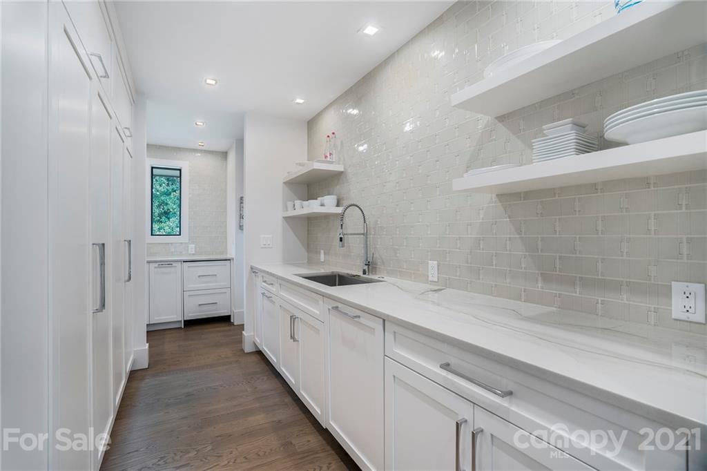 5201 Addison Drive Charlotte, NC 28211 - Photo 20 of 48 a spacious bathroom with a double vanity sink a mirror and a bathtub