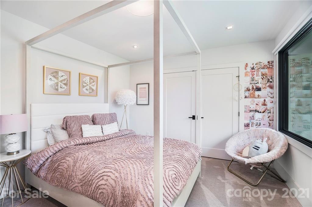 5201 Addison Drive Charlotte, NC 28211 - Photo 26 of 48 a bedroom with a bed and a chandelier