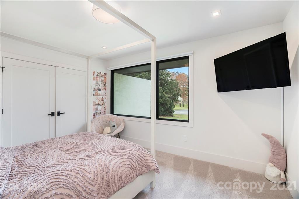 5201 Addison Drive Charlotte, NC 28211 - Photo 27 of 48 a bedroom with a large bed and a flat screen tv