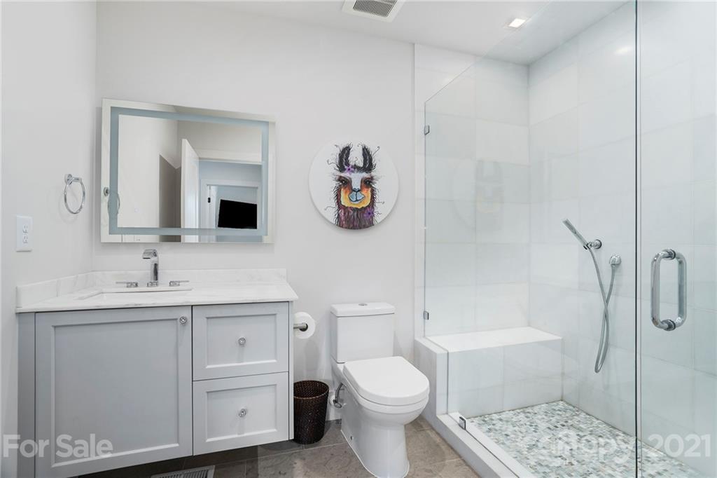 5201 Addison Drive Charlotte, NC 28211 - Photo 28 of 48 a bathroom with a toilet sink vanity granite and shower