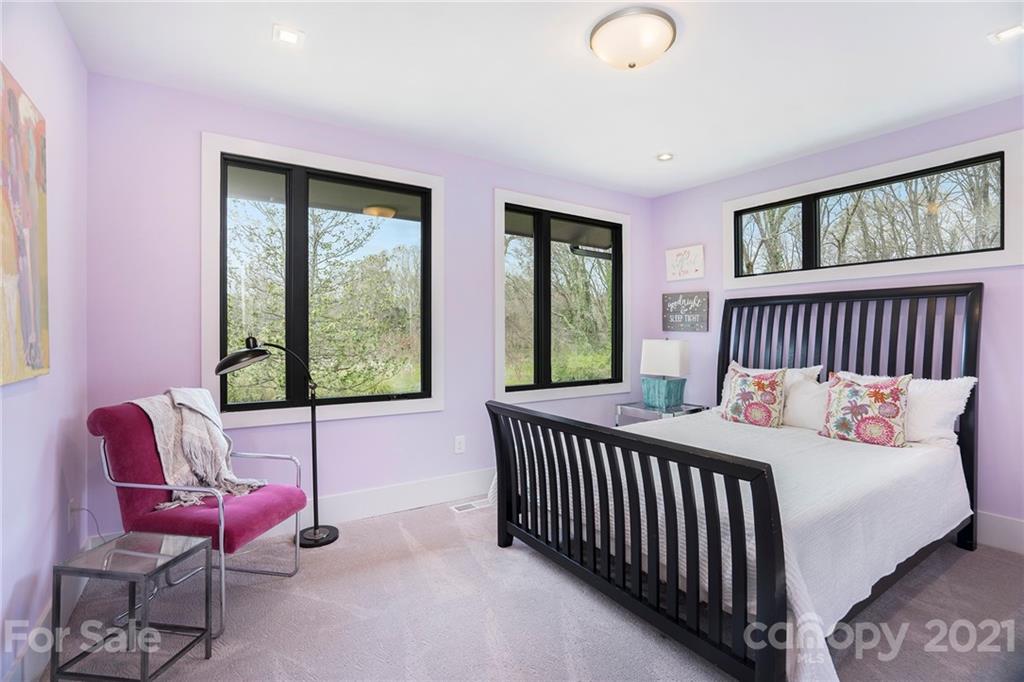 5201 Addison Drive Charlotte, NC 28211 - Photo 29 of 48 a bed sitting in a bedroom next to a window