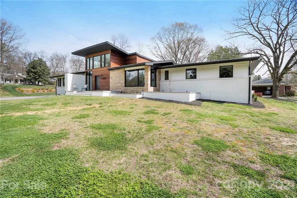 5201 Addison Drive Charlotte, NC 28211 - Photo 4 of 48 a big white house with a big yard and large trees