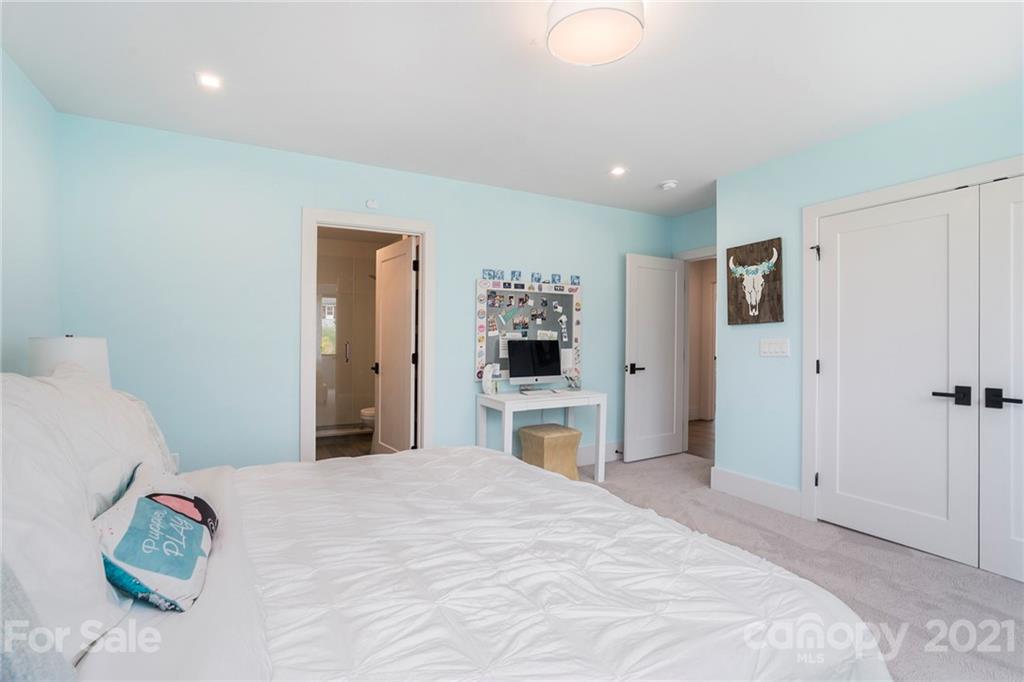 5201 Addison Drive Charlotte, NC 28211 - Photo 32 of 48 a bedroom with a large bed and chandelier