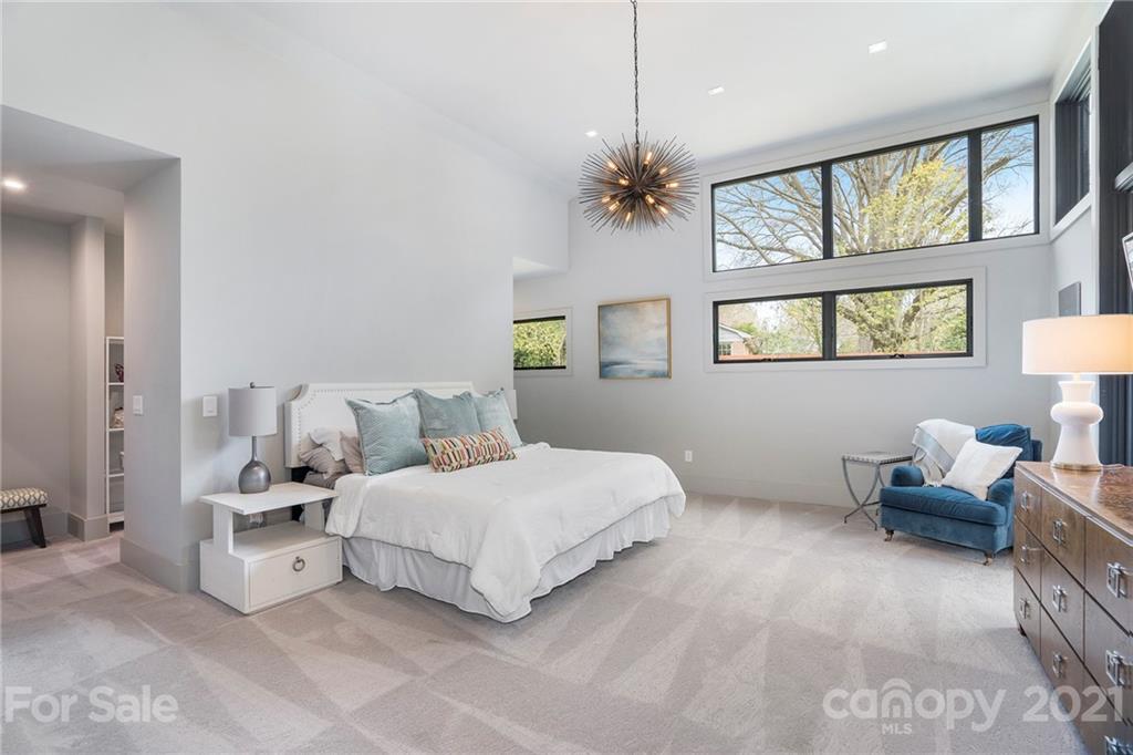 5201 Addison Drive Charlotte, NC 28211 - Photo 36 of 48 a bedroom with a bed ceiling fan and a window