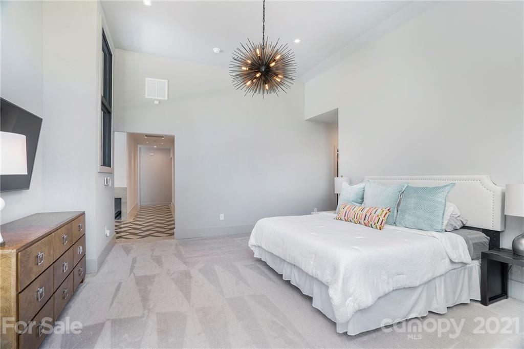 5201 Addison Drive Charlotte, NC 28211 - Photo 37 of 48 a bedroom with a bed and a chandelier