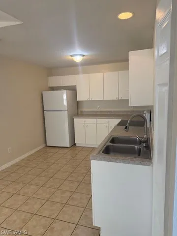 a utility room with sink dryer and washer