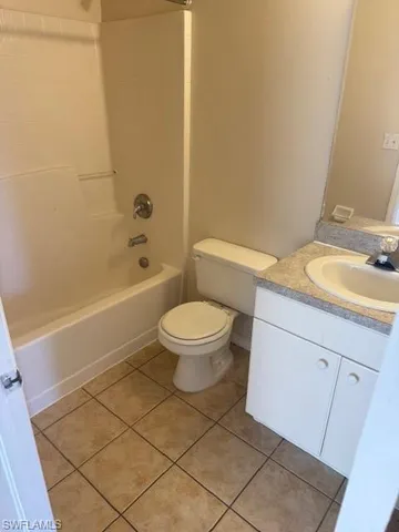 a bathroom with a granite countertop toilet a sink and a bathtub