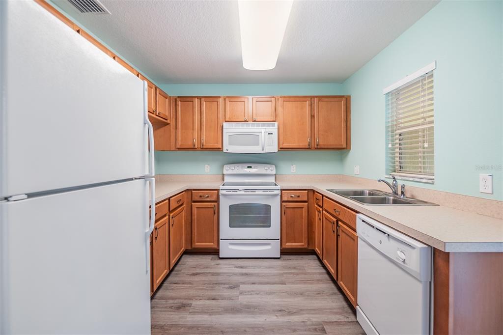 10906 Keys Gate Drive Riverview, FL 33579 - Photo 12 of 37 a kitchen with granite countertop a sink stove and refrigerator
