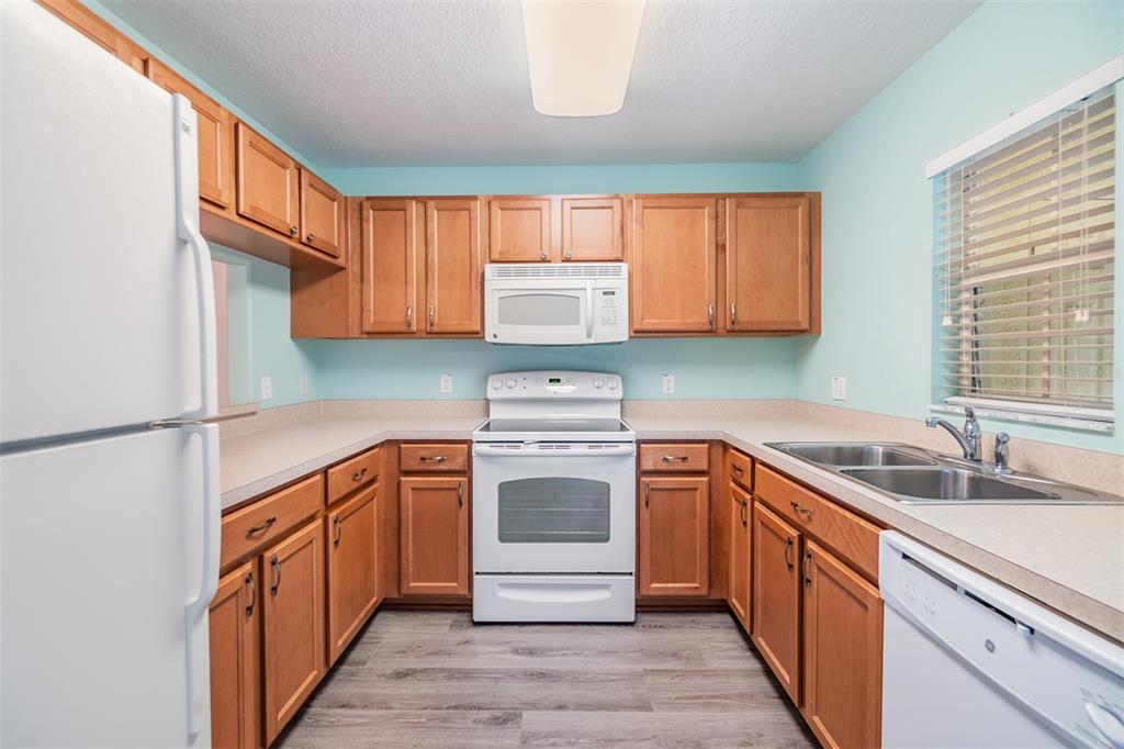 10906 Keys Gate Drive Riverview, FL 33579 - Photo 13 of 37 a kitchen with stainless steel appliances granite countertop a sink stove cabinets and a refrigerator