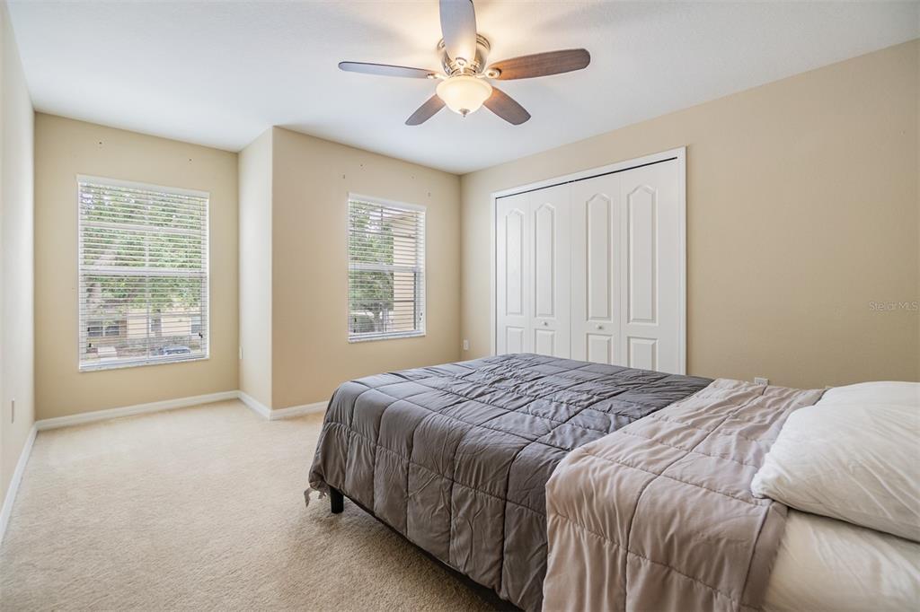 10906 Keys Gate Drive Riverview, FL 33579 - Photo 18 of 37 a bedroom with a bed chandelier and a window