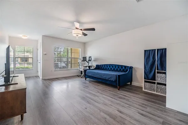 a living room with furniture and a wooden floor