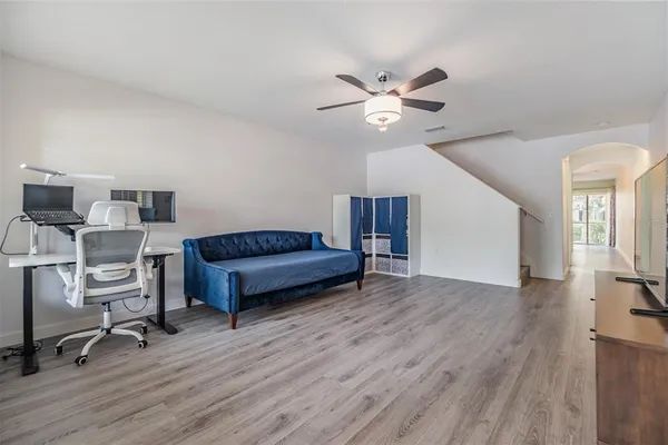 a living room with furniture and a wooden floor